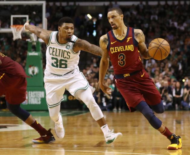 Cavs guard George Hill drives as he is trailed by Celtics defender Marcus Smart. Photo: Getty Images