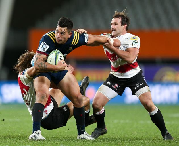 Thompson of the Highlanders is tackled by Andries Coetzee and Nic Groom of the Lions at Forsyth Barr Stadium on Saturday night. Photo: Gregor Richardson