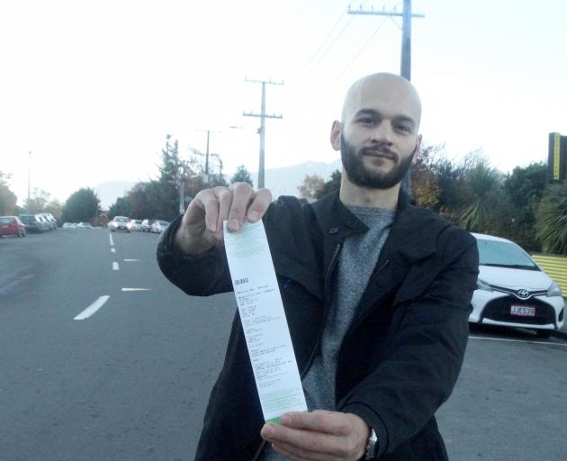 Marco Adreani displays a ticket issued for freedom camping in Queenstown. Photo: Mandy Cooper