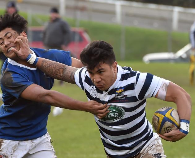 Otago Boys' High School flanker Josiah Lesa fends off Southland Boys' High School centre Junior Lafoga during their interschool match yesterday afternoon. Photo: Gregor Richardson