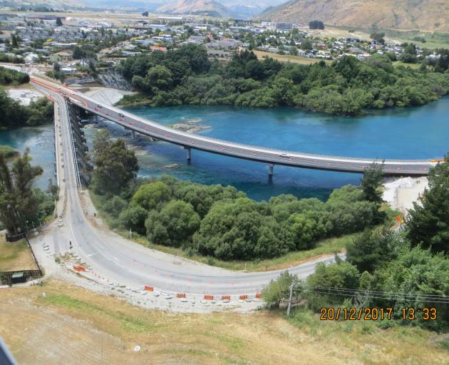 The $22million new curved Kawarau Falls Bridge next to the old structure. And plenty of houses in...