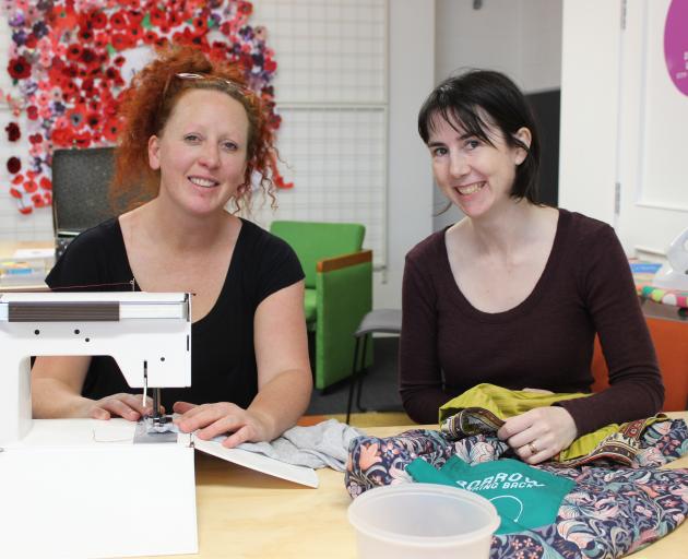 Studio 2 arts facilitator Zoe Fox (left) is helped by Bags for Good co-ordinator Fiona Jenkin to make bags out of old materials. PHOTO: ELLA STOKES Studio 2 arts facilitator Zoe Fox (left) is helped by Bags for Good co-ordinator Fiona Jenkin to make bags out of old materials. PHOTO: ELLA STOKES