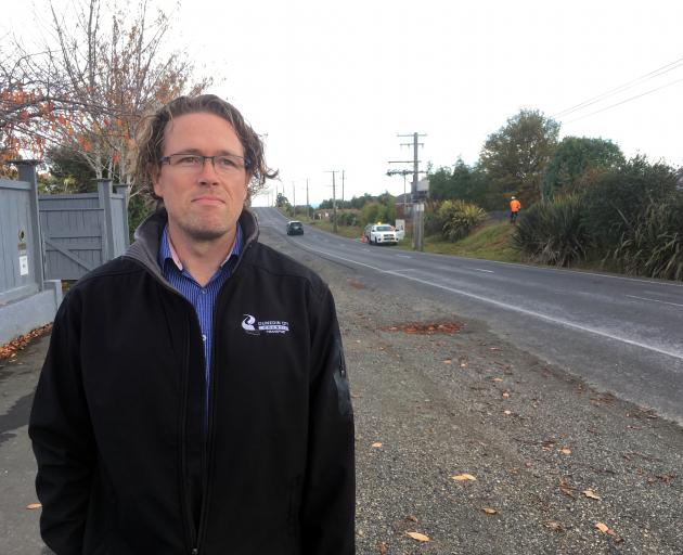 Dunedin City Council transportation safety team leader Hjarne Poulsen inspects a section of Gladstone Rd N where footpath improvements are planned. PHOTO: SHAWN MCAVINUE