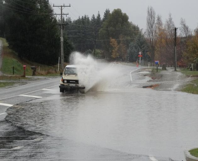 A motorist takes on severe surface flooding in Aubrey Rd, Wanaka, that submerged an entire lane...