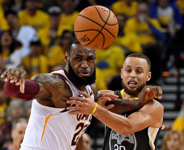 Superstars LeBron James (left) and Steph Curry battle for the ball in the NBA finals. Photo: Reuters