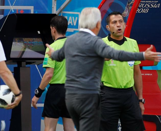 Referee Andres Cunha reviews a incident on VAR before awarding a penalty to France during its...