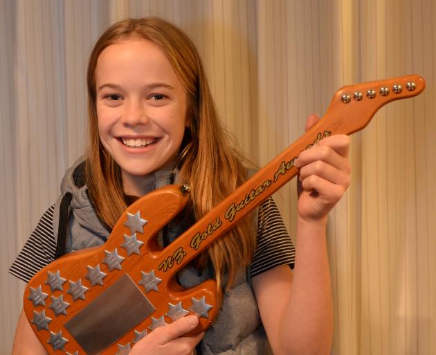 Dunedin country singer Gracie Young (13) proudly holds the award she won for best overall junior...