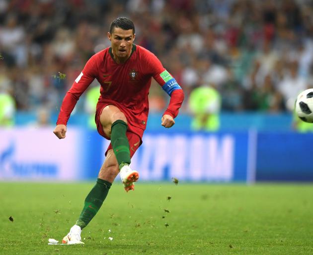Cristiano Ronaldo, of Portugal, scores his team’s third, match-tying goal from a free kick during...