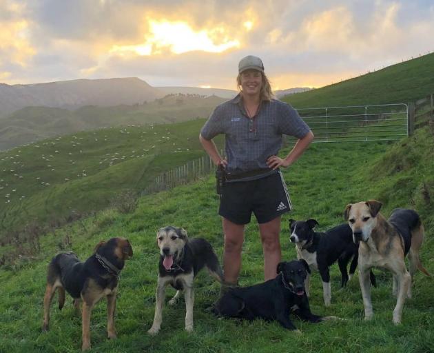 Mairi Whittle, 28, on the farmer with five or her six working dogs. Photo: NZME
