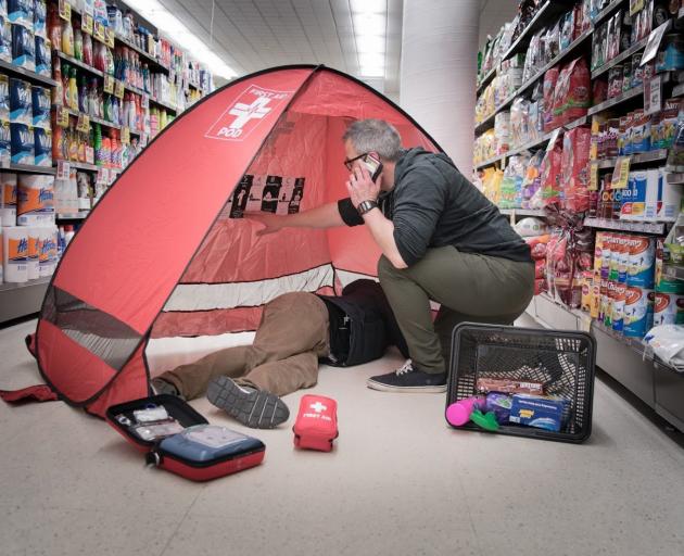 Tony Watts demonstrates the use of a First Aid Pod in a Dunedin supermarket.  PHOTOS: SUPPLIED