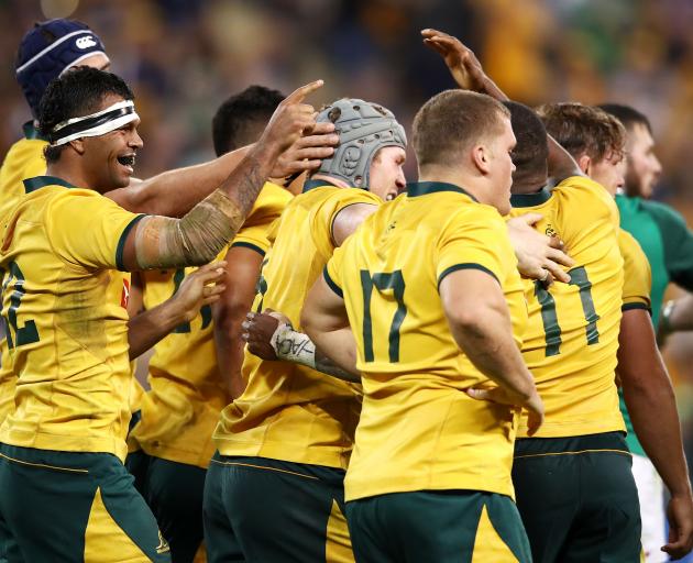 David Pocock of the Wallabies celebrates with his team mates after scoring a try. Photo: Getty...