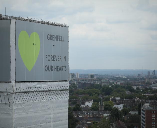  A sign with 'Grenfell Forever In Our Hearts' is displayed on the top of Grenfell Tower on June...