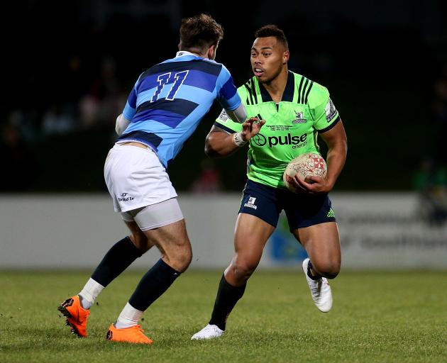 Highlanders wing Tevita Li (right) prepares to fends off French Barbarians opposite number Hugo...