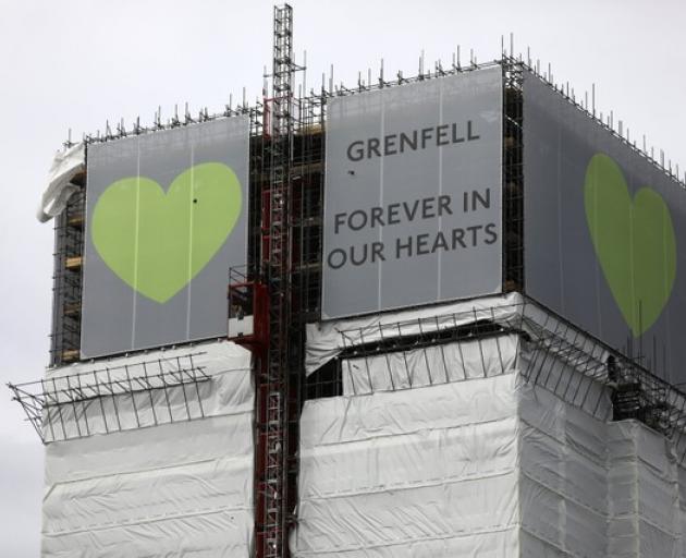 New hoarding covers the top of the Grenfell Tower to mark the first anniversary of the fire that killed 71 people at the social housing tower block in west London. Photo: Reuters