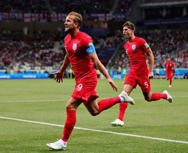 Harry Kane celebrates scoring his first of two goals for England against Tunisia this morning....
