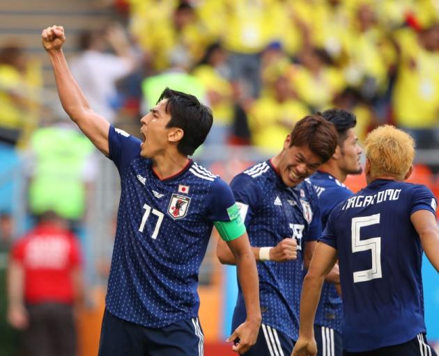 Makoto Hasebe celebrates with team mates during Japan's win over Colombia. Photo: Getty Images