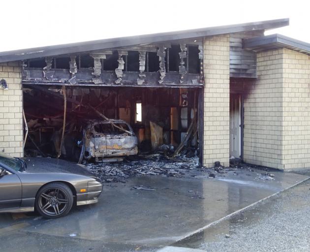 A car, garage and part of a residential property in Lake Hayes Estate, between Arrowtown and Frankton, sustained significant damage after the car went on fire early yesterday morning. Photo: Tracey Roxburgh