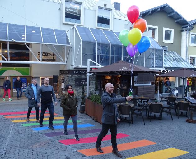Winter Pride co-director Martin King (right) is followed by Anya Henarath, Winter Pride co-director Mike Hughes and Craig Watson on Queenstown's new rainbow crossing, officially opened by Queenstown Lakes Mayor Jim Boult last night. Photo: Tracey Roxburgh