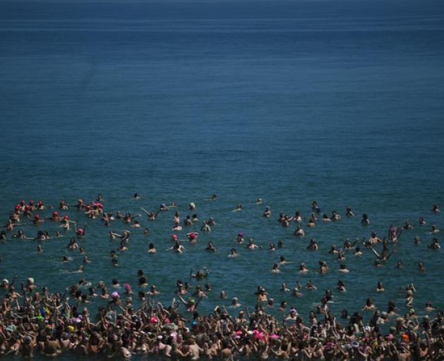 Women break a Guinness World record skinny dipping together and at the same time raising money for the children's cancer charity 'Aoibheann's Pink Tie' on Magheramore beach. Photo: Reuters