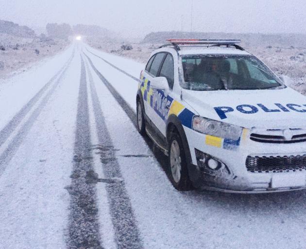 A police car is one of the few vehicles on this stretch of road near Queenstown yesterday.