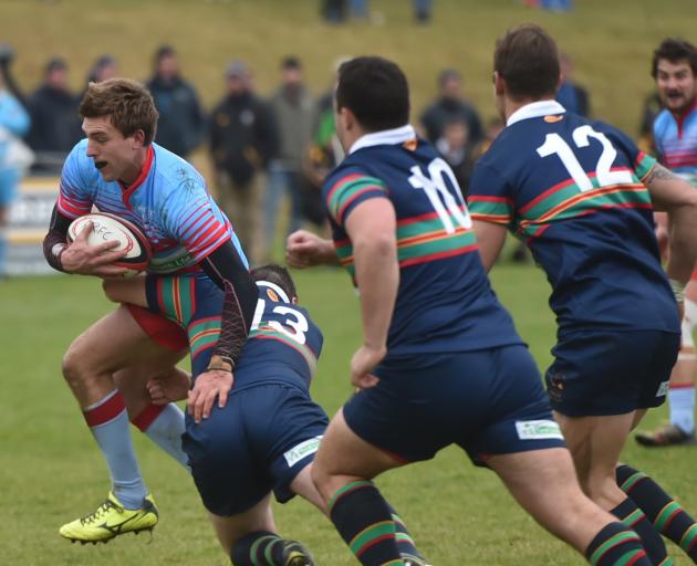 South Otago centre Jonny Sargent breaks the tackle of Central Otago opposite number Angus Gibb on...