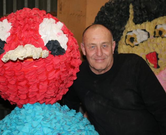 Alexandra Blossom Festival event manager Martin McPherson is surrounded by floats for the festival made with crepe paper, which is now hard to obtain in New Zealand. Photo: Tom Kitchin