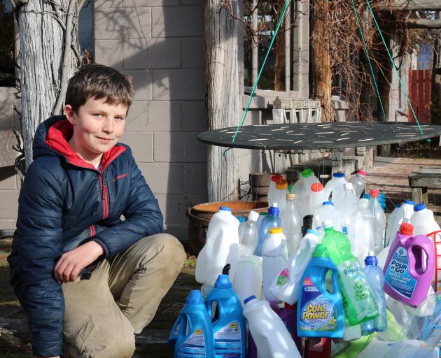 "Glow at The Packing Shed'' event organiser Jack Farrell (12) of Alexandra, holds a chandelier made of plastic bottles, designed and created by The Terrace School pupils. Photo: Tom Kitchin