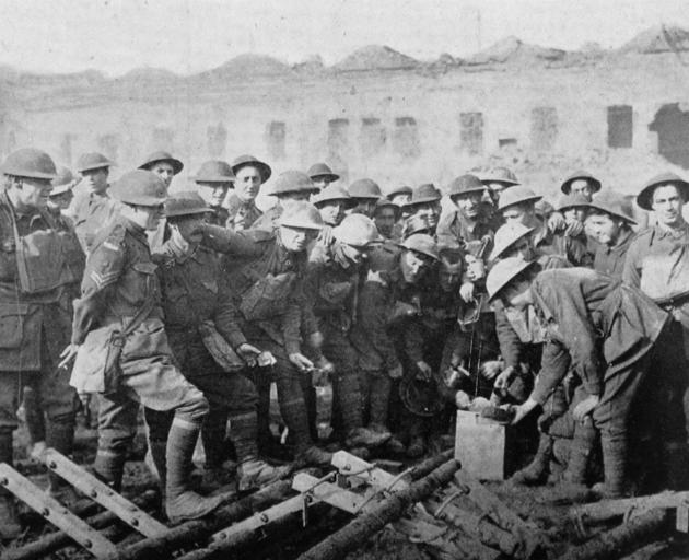 Australian troops receiving their rations in a ruined town, near the front in France. - Otago...