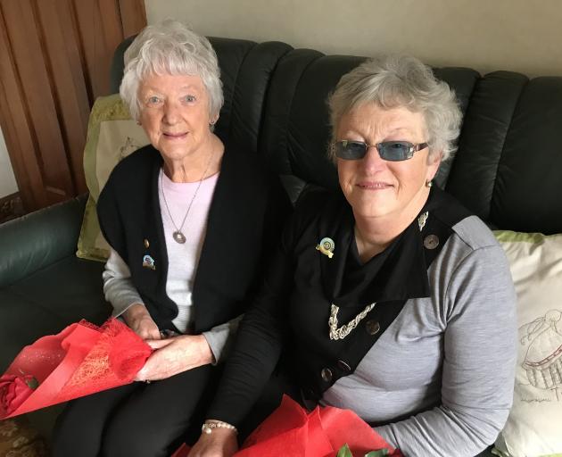 Cradling the roses they received are Balclutha Inner Wheel founding members Mary Hay (left) and Pam Henderson. Photo: Emma Perry