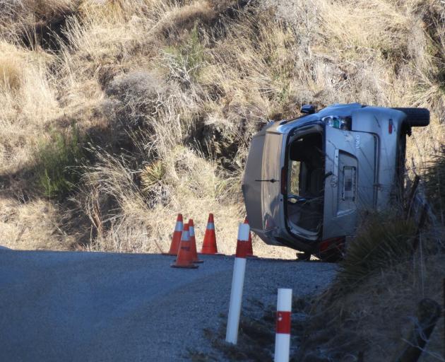 A motorist was injured in after their car rolled on the Crown Range Rd this morning. Photo: Sean Nugent