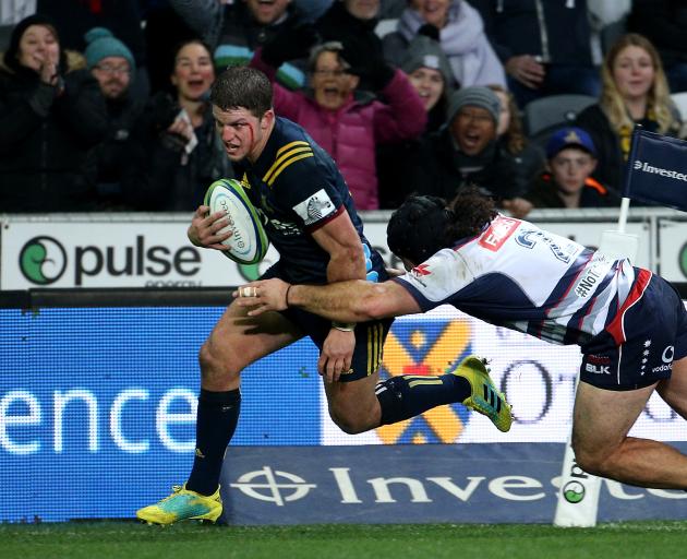 A bloodied Teihorangi Walden runs in a try for the Highlanders in their win over the Rebels...