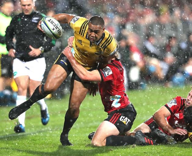 Hurricanes winger Julian Savea is tackled during the side's last meeting with the Crusaders....