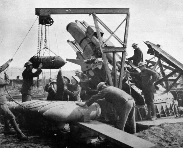 Gunners manhandle shells for one of the huge guns used against the Germans during their recent...