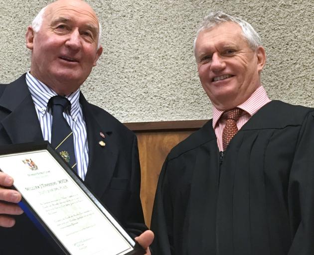 Long-serving Justice of the Peace Bill Townsend, of Alexandra, (left) is congratulated by Judge Michael Turner on more than 25 years of service as a JP. Mr Townsend was honoured in a ceremony in the Alexandra District Court yesterday. Photo: Pam Jones