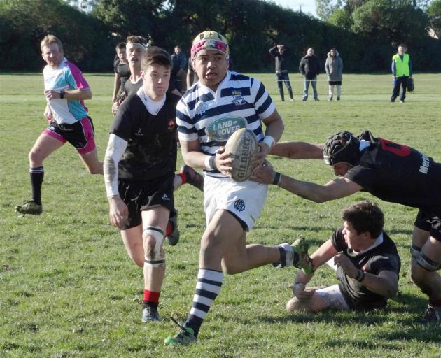 Otago Boys' High School first five-eighth Tevita Asi breaks through the Waitaki Boys' High School defence during the schools' first XV interschool clash at Milner Park in Oamaru yesterday. After leading 24-0 at halftime, Otago Boys' produced a sublime sec