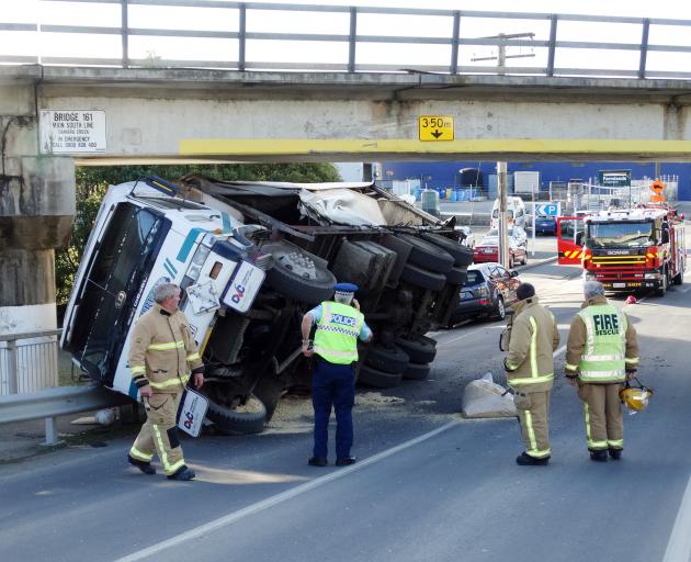 A truck lies on its side after hitting a rail overbridge in Humber St in Oamaru yesterday. Photo:...