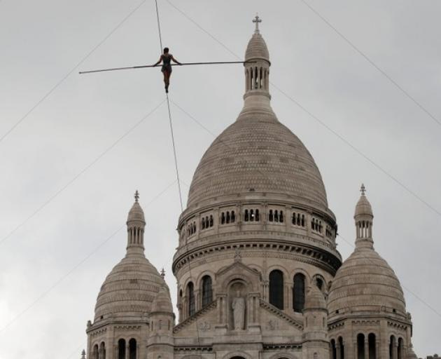 Tatiana-Mosio Bongonga advances on a tightrope as she scales the Monmartre hill towards the Sacre Coeur Basilica. Photo: Reuters