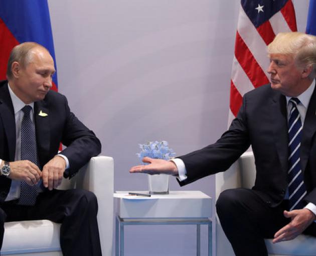 US President Donald Trump (right) meets with Russian President Vladimir Putin during their...