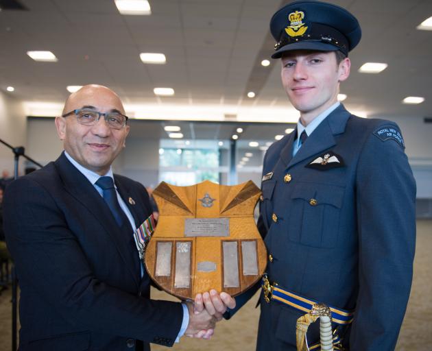Defence Minister Ron Mark presents Pilot Officer George Bellamy with the Baigent Memorial Shield....