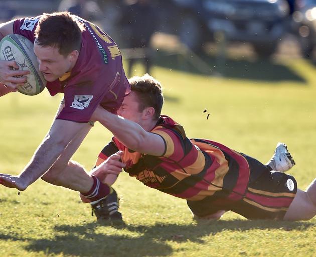 Alhambra Union centre Brad Morgan is tackled by Zingari fullback Devin Redfern during the premier...