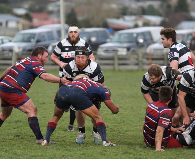 Crescent prop Logan Morrell tries busting through the tackle of Clutha Valley back Crewze Kingi...