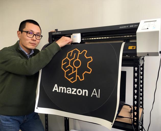 Happy Moose founder Alex Dong checks the knife on a cutter creating a dot decal for electronic commerce giant Amazon in Dunedin last week. Photo: Shawn McAvinue