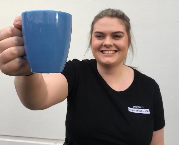 Potpourri Vegetarian Cafe barista India Smith, of Dunedin, displays a ceramic mug from a mug library in the cafe to reduce the use of disposable coffee cups. Photo: Shawn McAvinue Potpourri Vegetarian Cafe barista India Smith, of Dunedin, displays a ceramic mug from a mug library in the cafe to reduce the use of disposable coffee cups. Photo: Shawn McAvinue