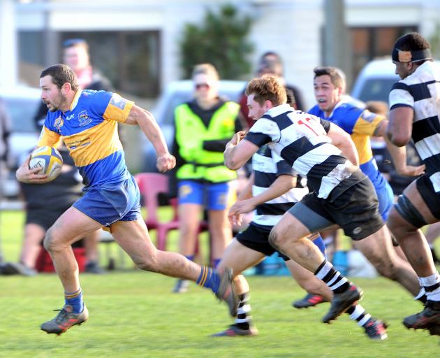 Taieri midfield back Kori Rupune heads for the tryline chased by Southern defenders (from left):...