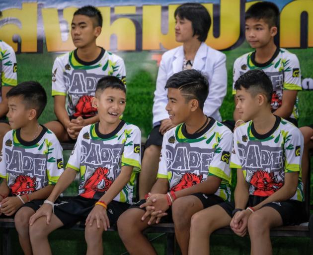 The Wild Boars team were making their first public appearance after the long ordeal, waving, smiling and offering Thai traditional "wai" greetings on a national TV broadcast. Photo: Getty Images