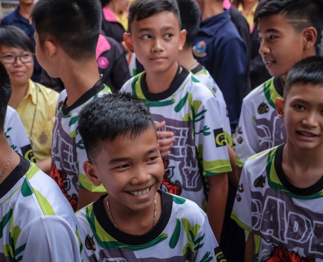 The 'Wild Boars' soccer team arrive for a press conference for the first time since they were rescued from a cave in northern Thailand last week. Photo: Getty Images