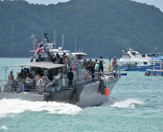 A Thai Royal Navy boat is seen during a searching operation for missing passengers of a capsized tourist boat at a pier in Phuket. Photo: Reuters