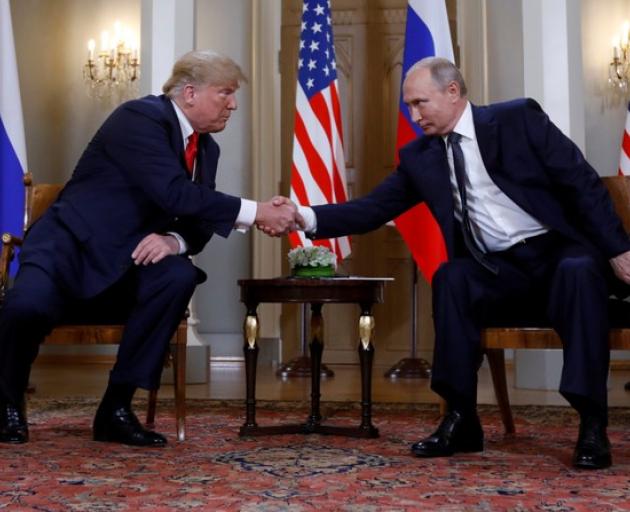 US President Donald Trump and Russia's President Vladimir Putin shake hands as they meet in Helsinki, Finland. Photo: Reuters