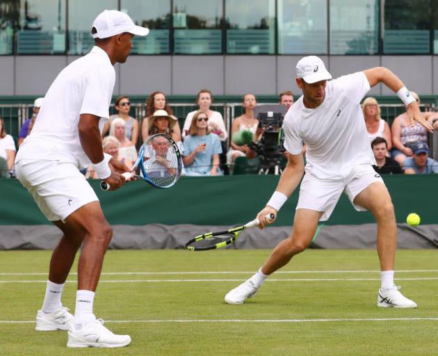 Raven Klaasen of South Africa and Michael Venus of New Zealand returns against Alex Bolt of Australia and Lleyton Hewitt of Australia. Photo: Getty Images