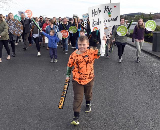 St Mary’s Primary School pupil Sam Clark (8), son of teacher Lyn Clark, leads the strike march in...